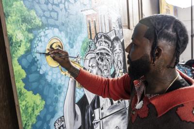 Artist Ernest Robert painting in his Slidell studio.