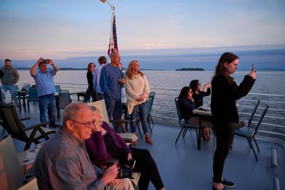 people taking photos of the sunset over Lake Champlain on the Spirit of Ethan Allen