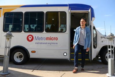 Metro micro passenger getting off bus.