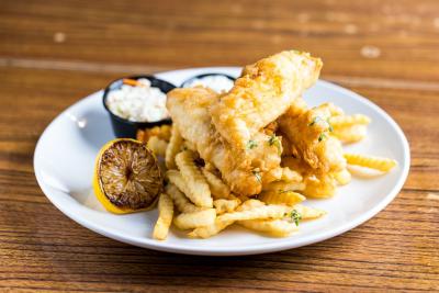 Fish Fry special at Wild Bill's Sports Saloon featuring two pieces cod, French fries, cole slaw and tartar sauce with a lemon slice.