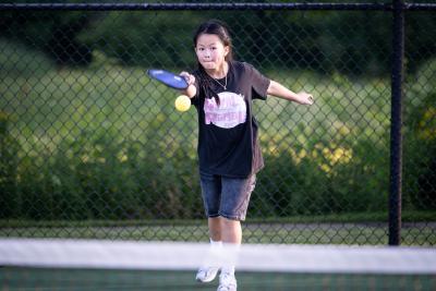 Pickleball player focused on hitting the ball at Pioneer Park.