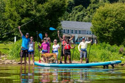 group of people having a great time paddle boarding in York County