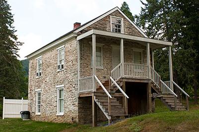 Stairs lead visitors up to the entrance of the historic Paymaster's Cabin in Pine Grove Furnace State Park.