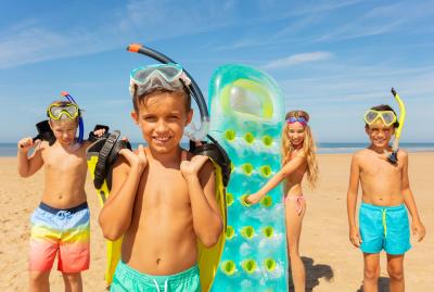 Kids on the Beach with Snorkeling Equipment and Water Toys