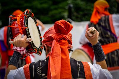 Japanese musician wearing bright orange headdress