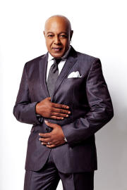 Peabo Bryson poses in a navy blue suit