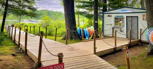 Wooden dock and boat rental shack on lake