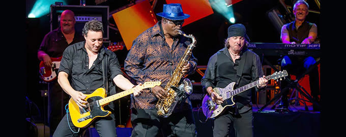 Artist Bruce in the USA playing the saxophone accompanied by band