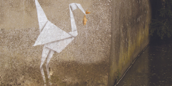 Banksy art work of origami crane holding a fish