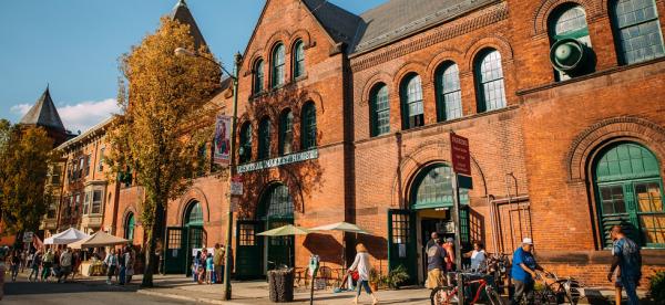 Exterior shot of Central Market House in autumn with people walking along the sidewalk
