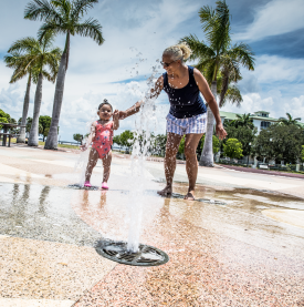 Grandma and granddaughter playing in the water at the Laishley Park Splash Pad