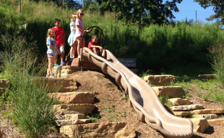 slide built into the side of a hill at nature play at Behringer-Crawford Museum in covington ky