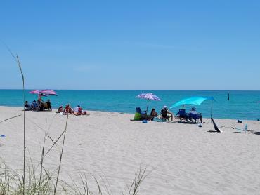 People enjoying the beach in Englewood, Florida, on a sunny May day.