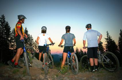 Four mountain bikers enjoying the view from Larch Mountain