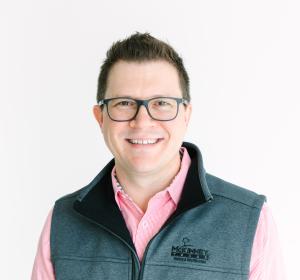 Tony Adamo smiling at camera