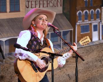 Miss Kristyn Harris Playing and sing for audience.