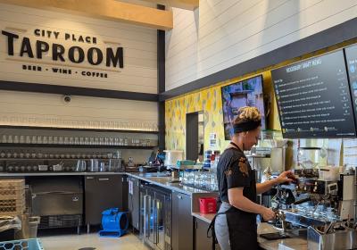 CityPlace Taproom with barista brewing a specialty coffee.