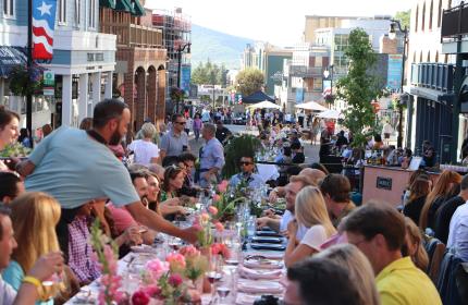 photo of people sitting at a table on Main Street Park City at the Savor the Summit event in 2012