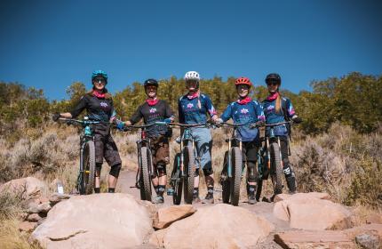 Women with mountains bikes smiling at the camera