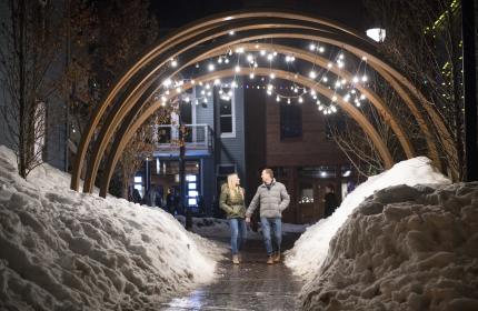 Couple under lighted arch on Main Street