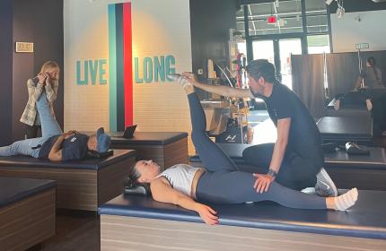 Clients and aids work on stretching muscles at StretchLab in Park City