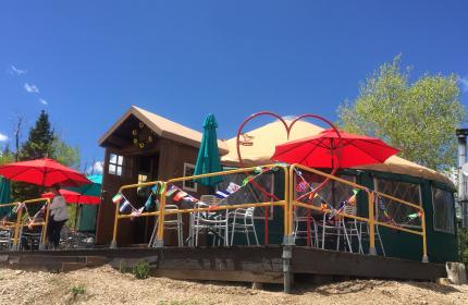 A patio with umbrellas outside of a yurt