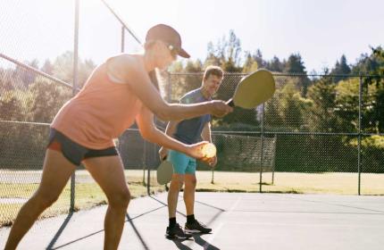 Two pickleball players begin a game at sunset in Park City, UT