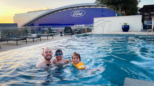 Father, son, and daughter swimming at Omni Frisco Hotel pool