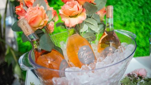 Three bottles of Rose Wine in a clear ice bucket
