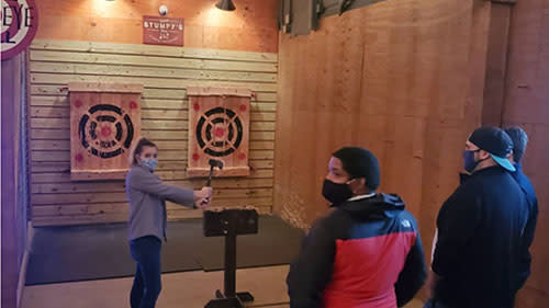 Teens throwing axes at Stumpy's Hatchet House in Irving, TX