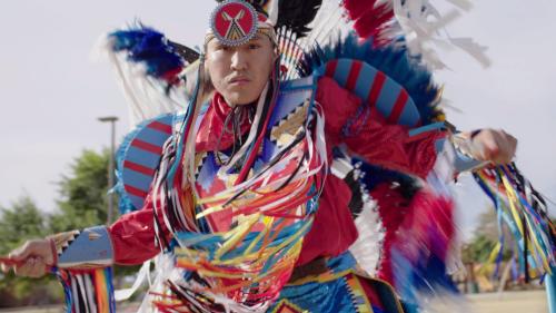 An indigenous man in traditional dress.
