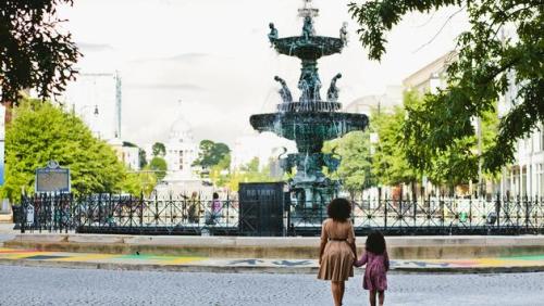 A woman and her daughter stand in front of the fountain in Montgomery, Alabama.