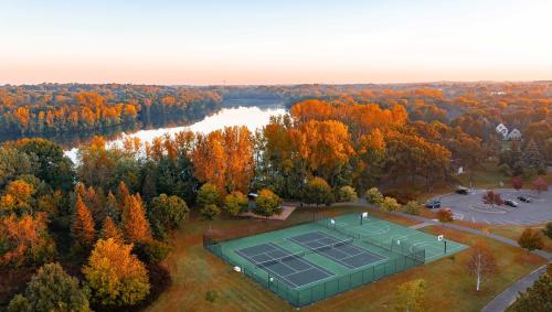 Edgewater Park aerial photo overlooking Colby Lake in the fall season with the foreground of the tennis and basketball courts