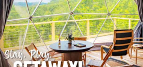 Standing inside Wander Ridge camping dome looking out at the landscape. Word overlay of Stay. Play. Getaway!