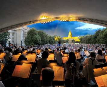 An orchestra performs at the City & County building overlooking Civic Center Park and the State Capitol Building