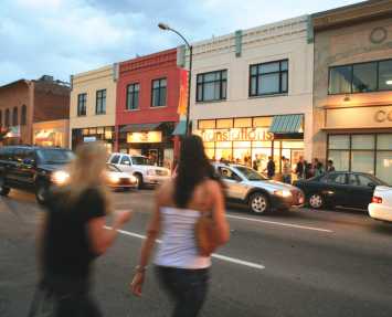 Two women crossing the street within the Art District on Santa Fe.