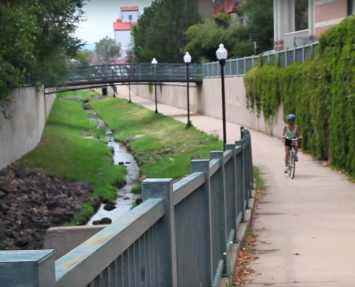 Bicycle rider on bike path in Littleton