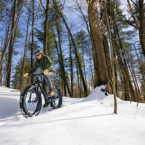 Man riding a mountain bike in the snow