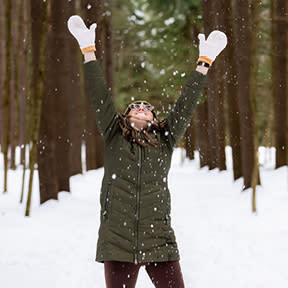 Woman throwing snow into the air