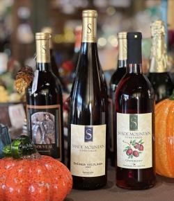 Picture of Shade Mountain Fall Wines sitting on counter beside pretty glass pumpkins.