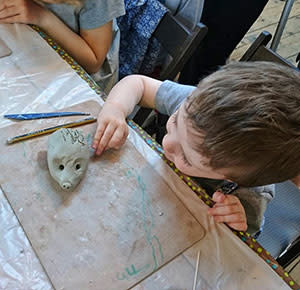 Child moulding clay at Middleport Pottery, Stoke-on-Trent. Image courtesy Dirt, Diggers & Dinosaurs