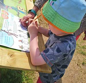 Taking part in the Stick Man Trail at National Memorial Aboretum, Staffordshire. Image courtesy Dirt, Diggers & Dinosaurs