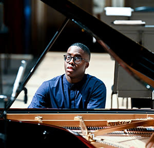 A young pianist sits at the piano