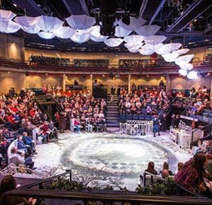 Image shows a packed house for a production at the New Vic Theatre, Newcastle-under-Lyme, Staffordshire
