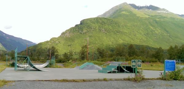 a skate park with mountains in the background