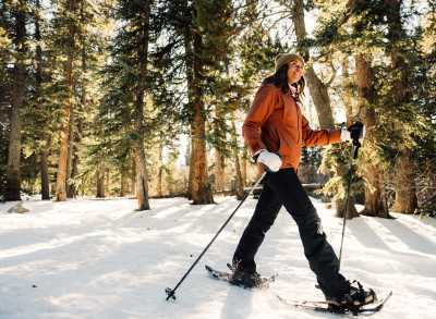 Woman snowshoeing in the forest near Denver, Colorado