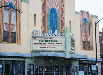 A sign at a Boulder Sundance venue promotes a film, snow is gently falling