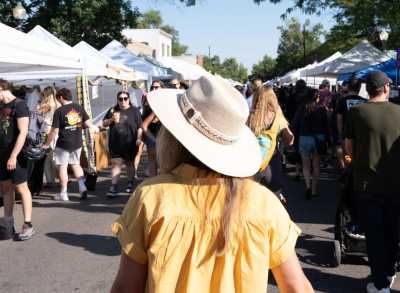 A person is walking through South Pearl Street Farmers' Market
