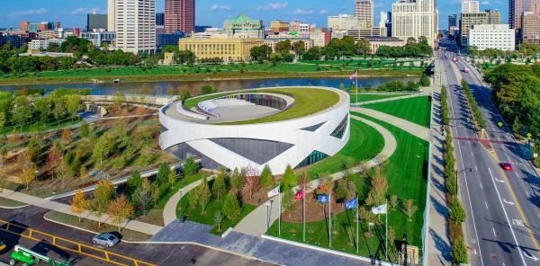 View from above of the National Veterans Memorial and Museum surrounded by grass and trees with skyline in background
