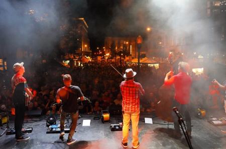 view from stage of men playing music at a street concert in covington ky